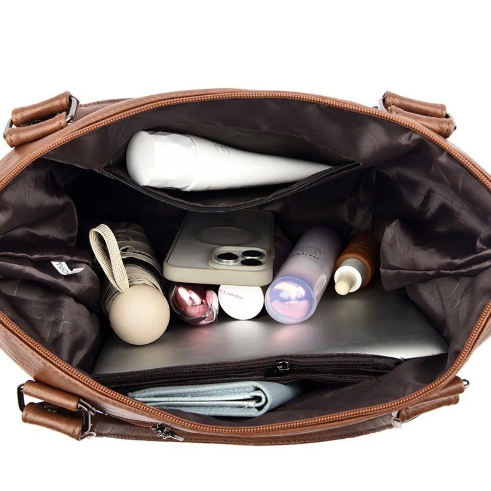 Open brown bag with various items including a phone and bottles