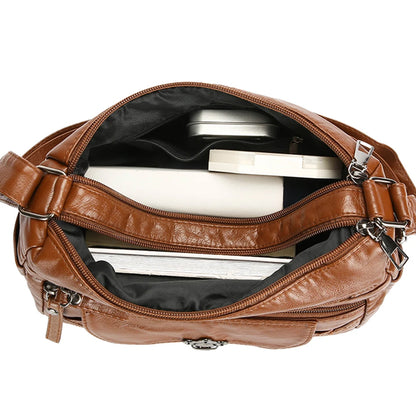 Brown leather bag with silver interior on a white background