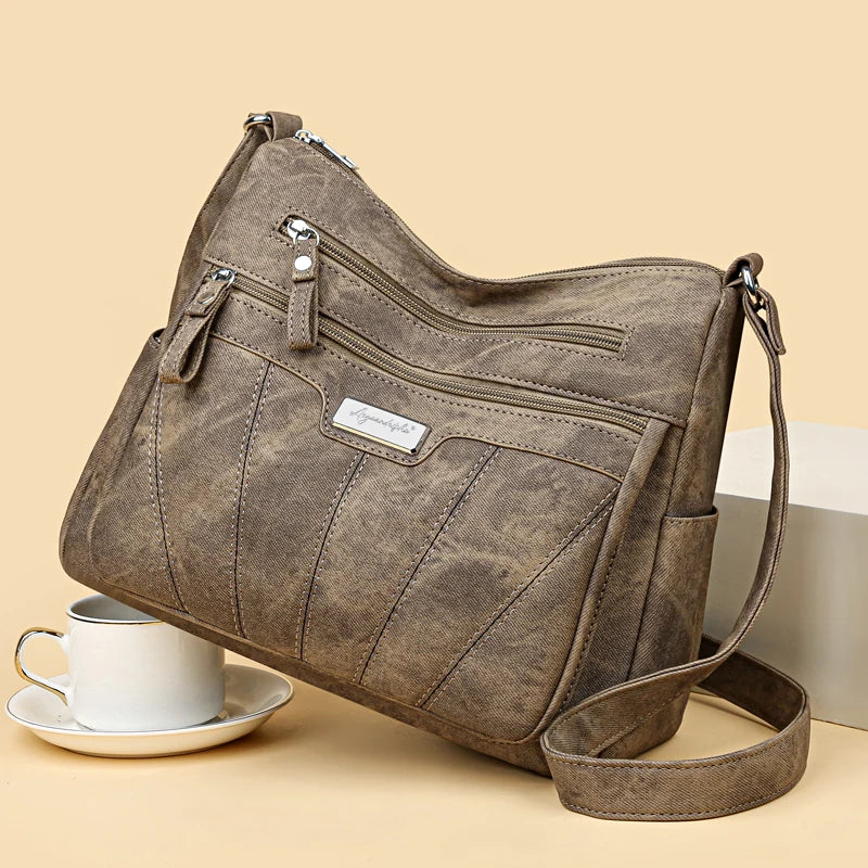 Brown handbag with a visible brand label on a beige background