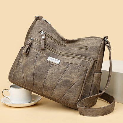 Brown handbag with a visible brand label on a beige background