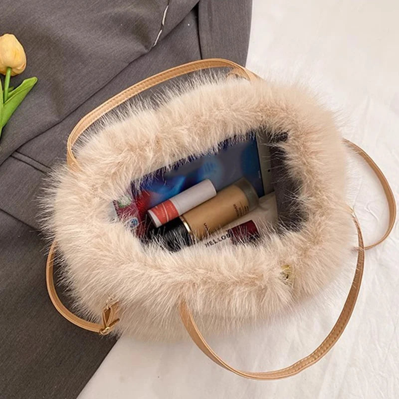 Fluffy handbag with makeup items on a textured surface