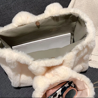 Close-up of a white fur-lined handbag with a leopard print handbag inside.