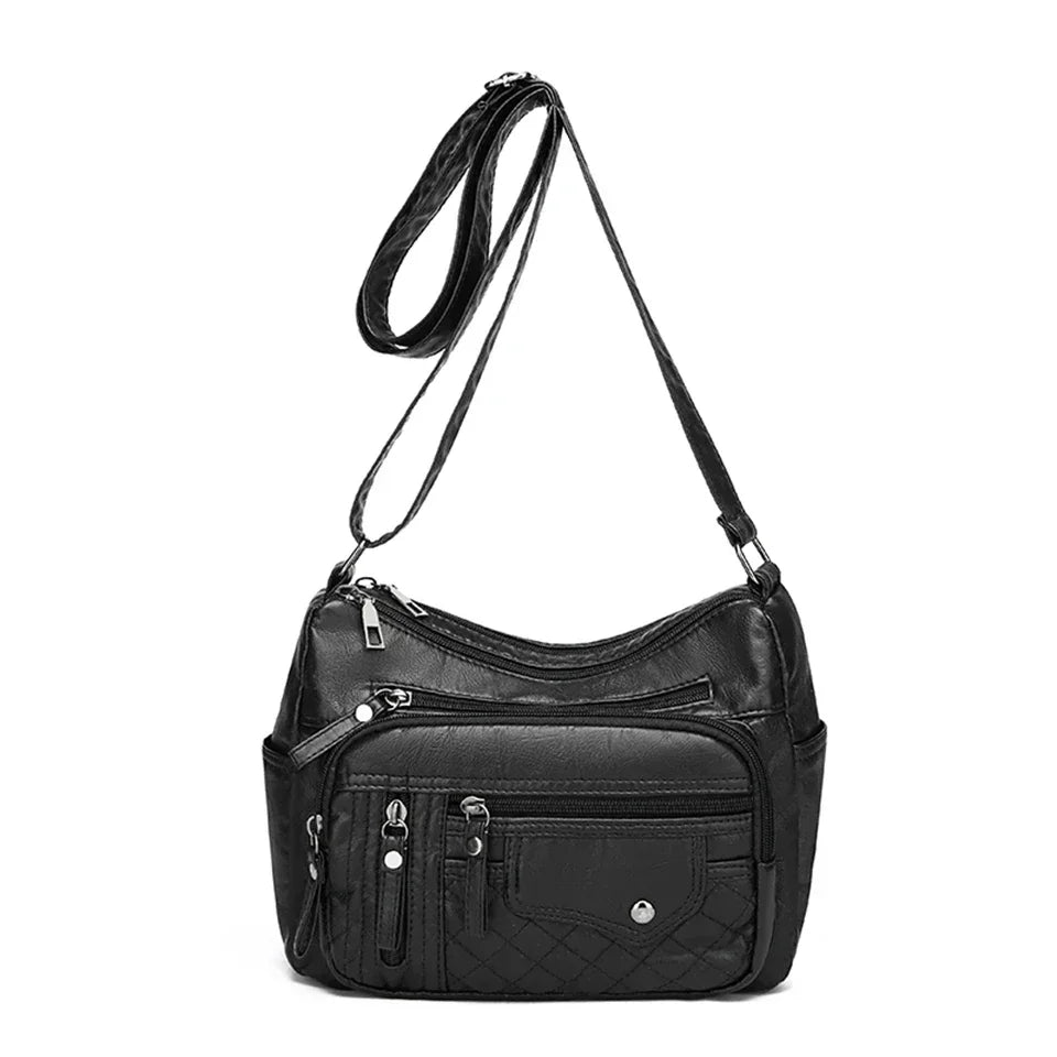 Black leather handbag with multiple pockets on a white background