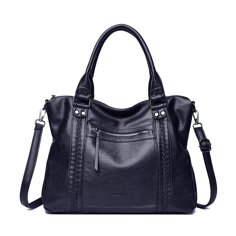 Black leather handbag with braided details on a white background