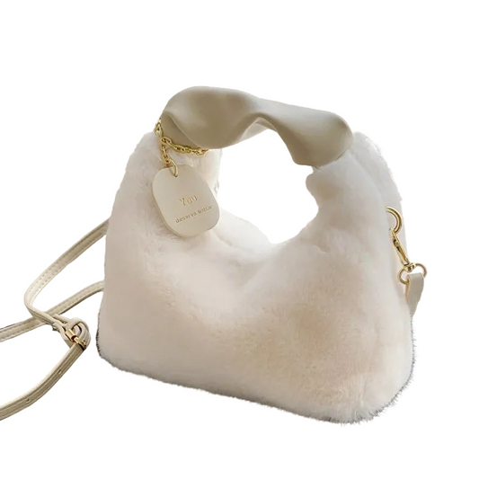 White fur handbag with gold chain handle on a white background