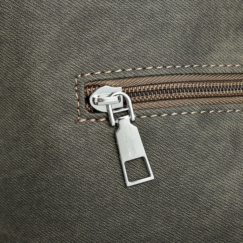 Close-up of a zipper on a textured fabric surface