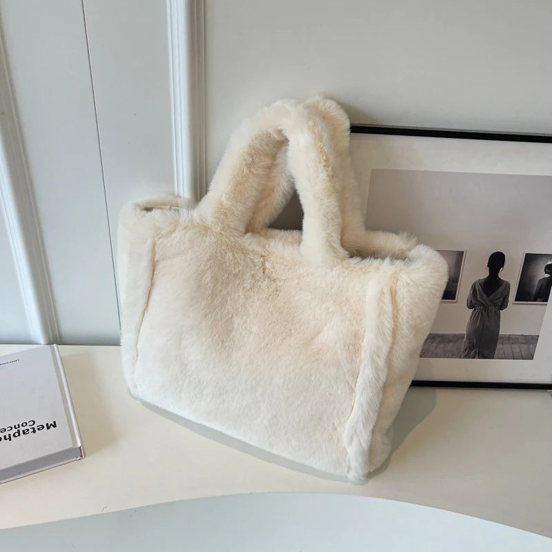 White fluffy handbag on a white surface with a minimal background