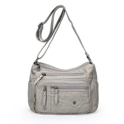 Gray shoulder bag with multiple pockets and zippers on a white background