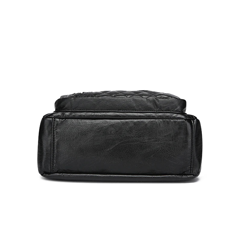Black leather bag with quilted design on a white background