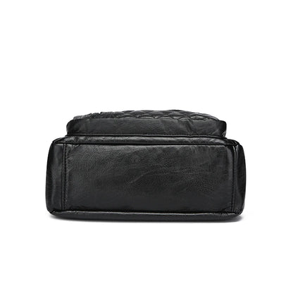 Black leather bag with quilted design on a white background