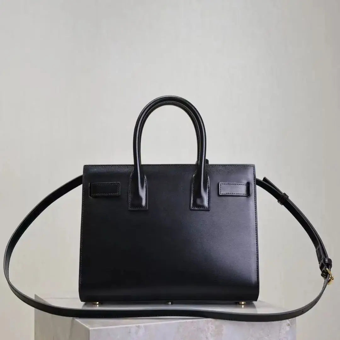 Black handbag on a light gray background