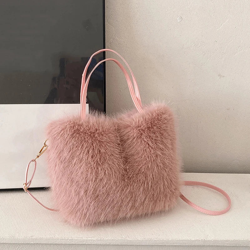 Pink fluffy handbag on a white surface with a neutral background