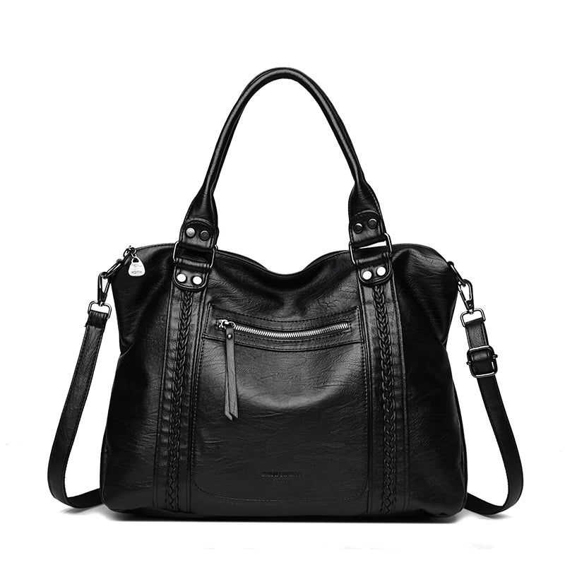 Black leather handbag with multiple pockets and straps on a white background