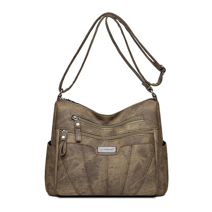 Brown shoulder bag with multiple pockets on a white background