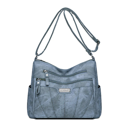 Blue handbag with multiple pockets and zippers on a white background