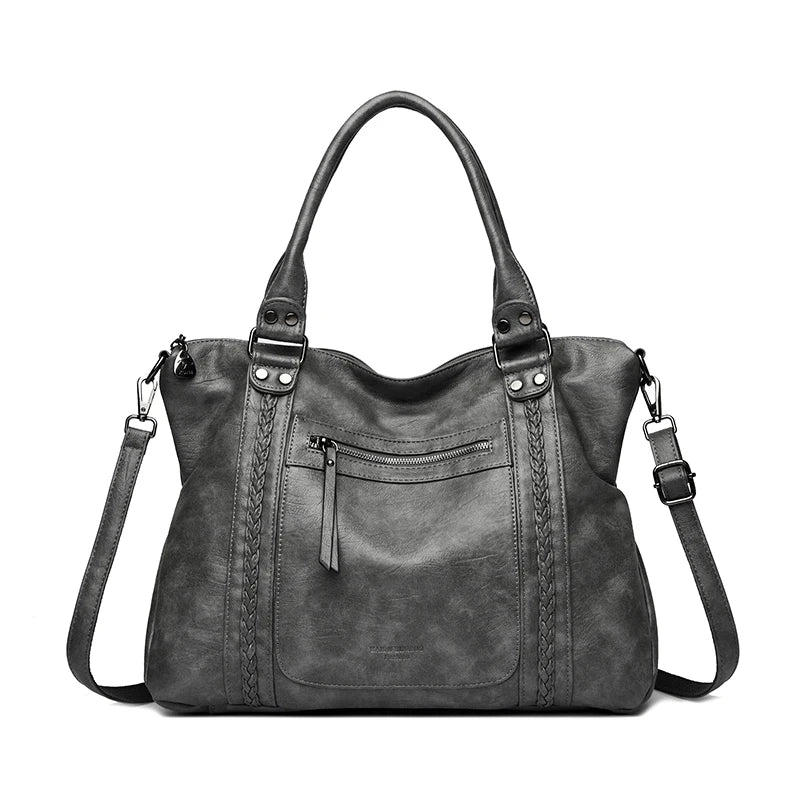 Gray handbag with multiple straps on a white background