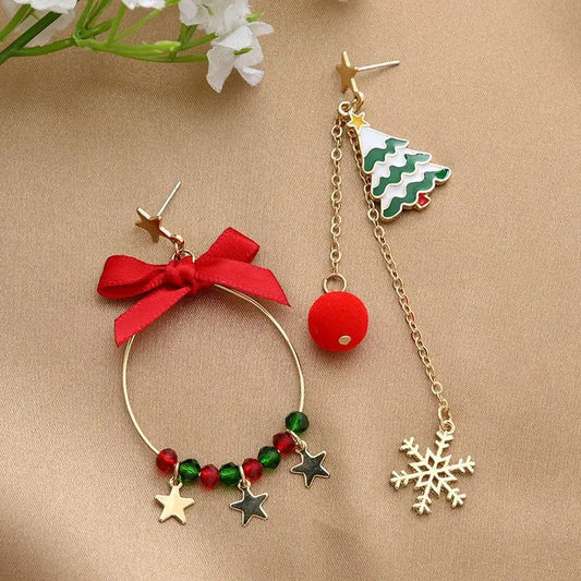 Two Christmas-themed earrings on a beige background with flowers.