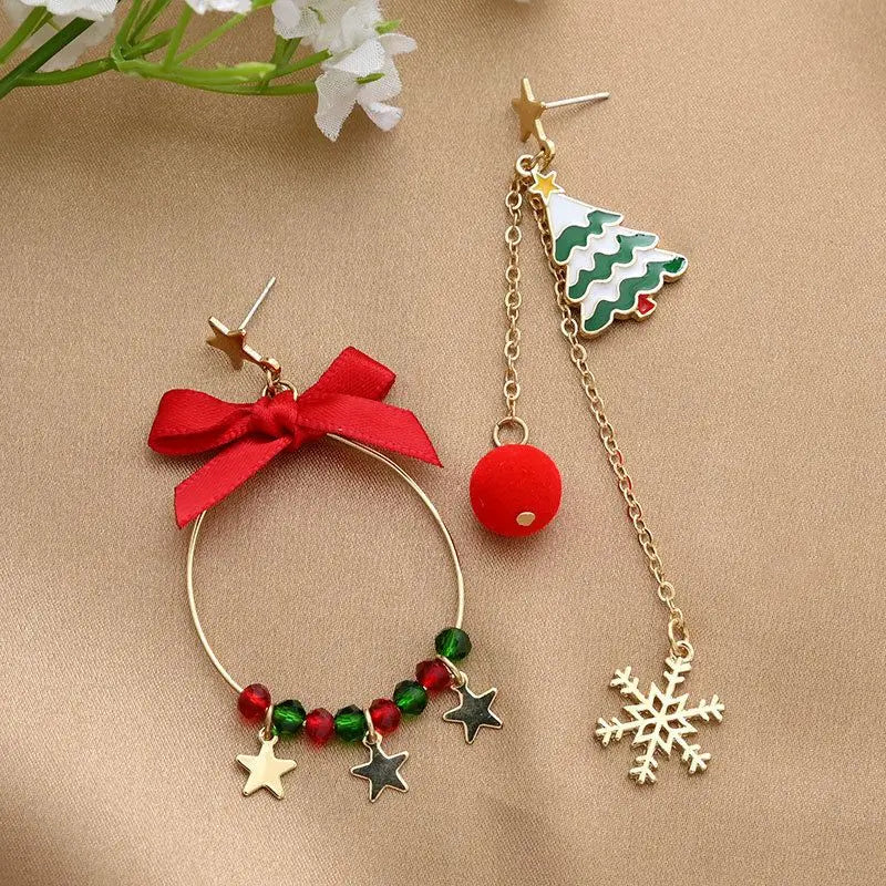 Two Christmas-themed earrings on a beige background with flowers.