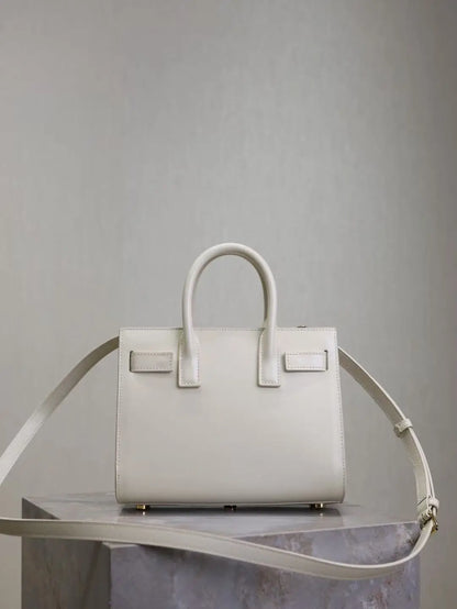 White handbag on a metallic stand against a gray background