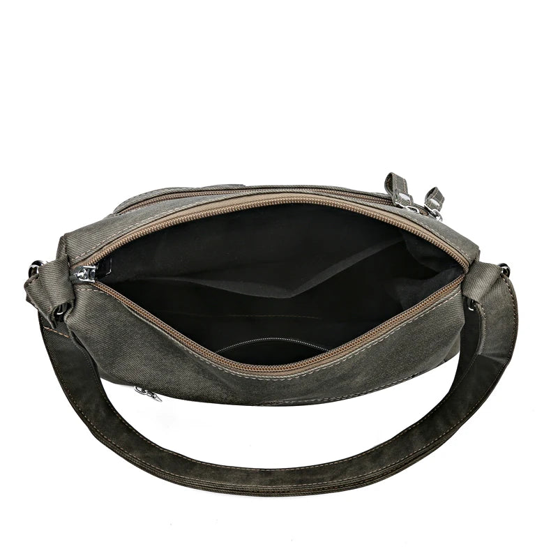 Gray shoulder bag with a black interior on a white background