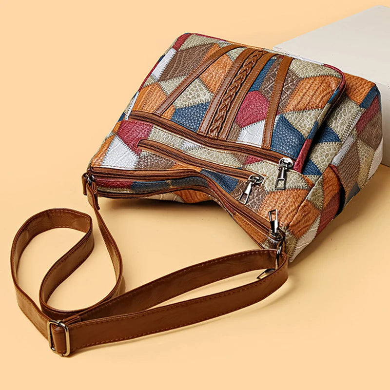 Multicolored patterned handbag with a brown strap on a beige background