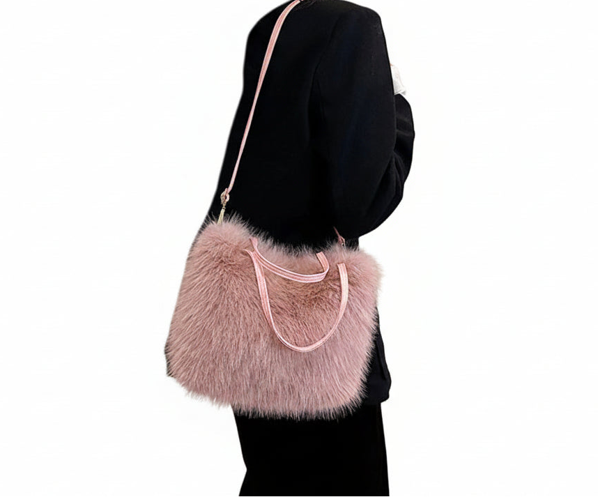 Person holding a fluffy pink handbag with a plain background