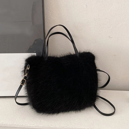 Black fur handbag with a strap on a light surface
