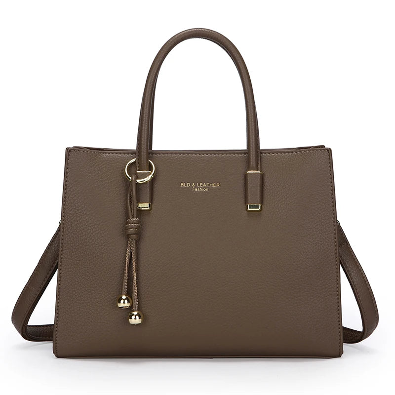 Elephant Grey leather handbag with a strap on a white background