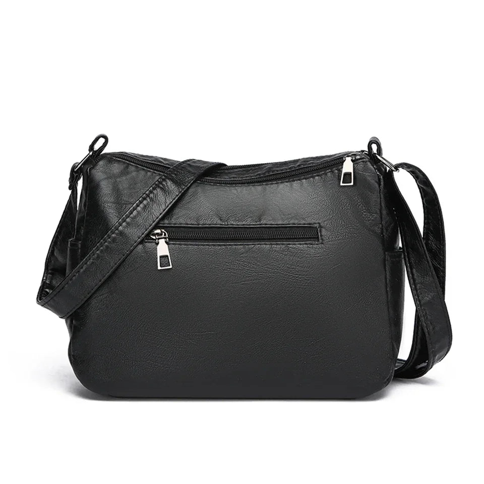 Black leather crossbody bag on a white background