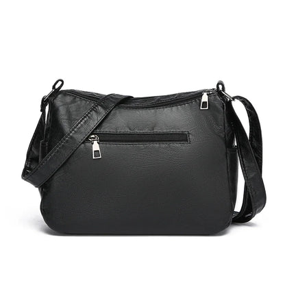 Black leather crossbody bag on a white background