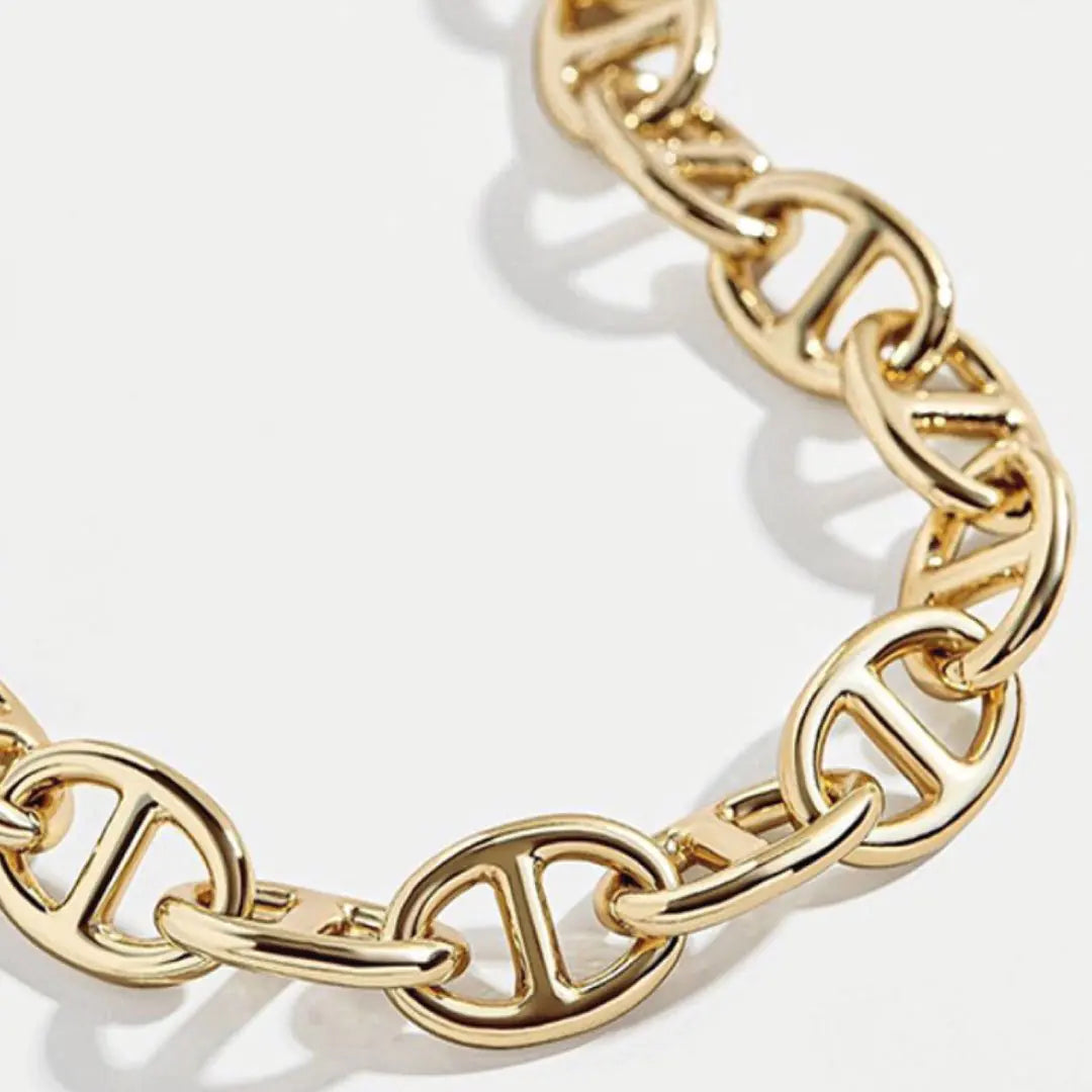 Gold chain bracelet on a white background