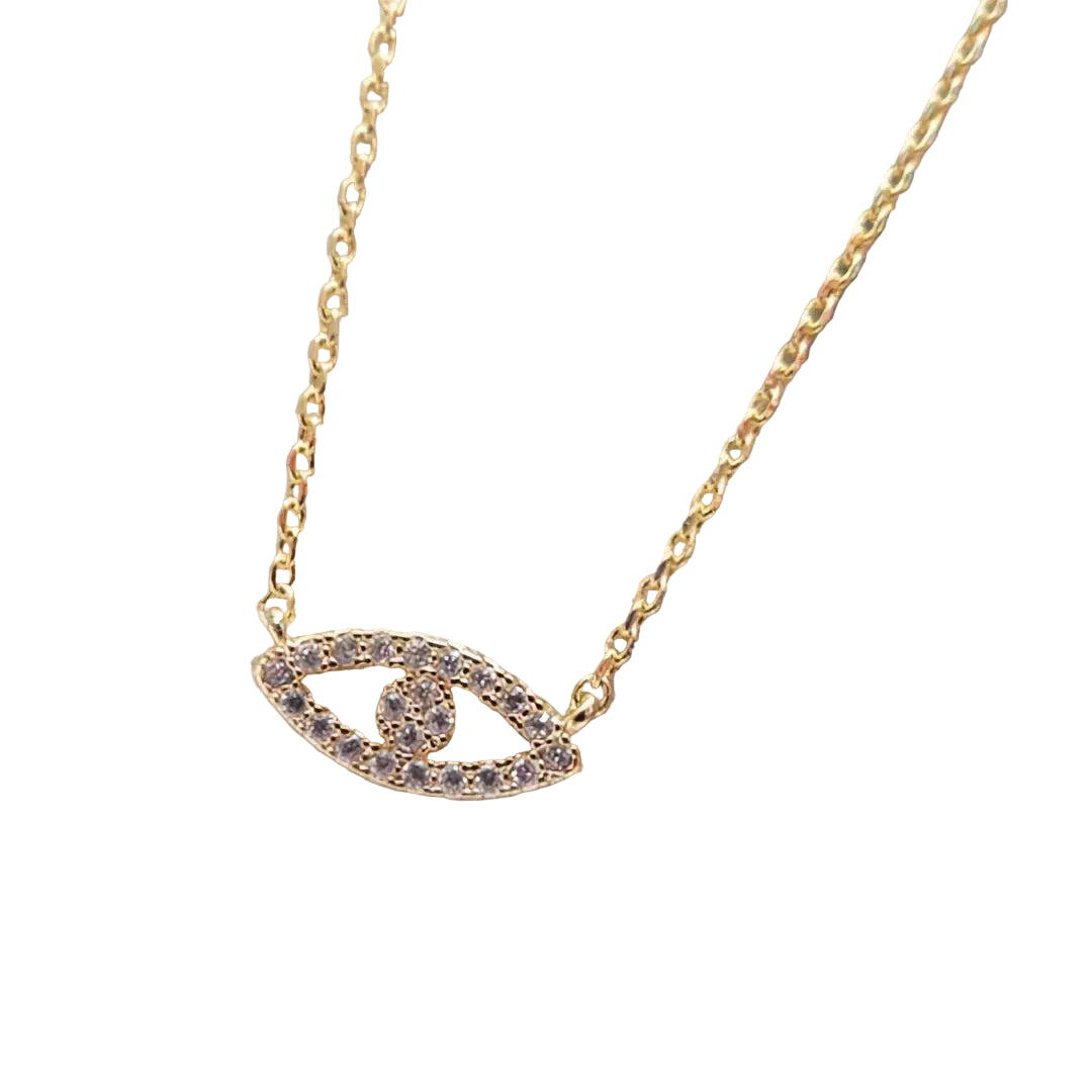 Gold necklace with an eye-shaped pendant on a marble background