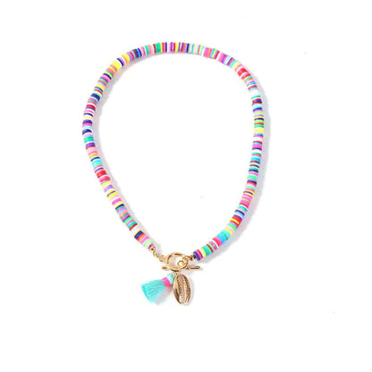 Boho shell necklace with multicolor ceramic beads and tassel charm – styled on neck and flat lay.